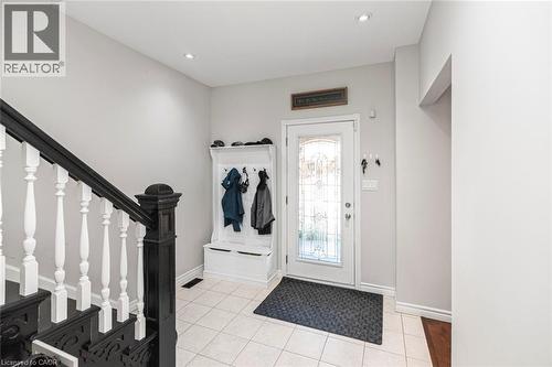 Foyer featuring a decorative glass-paneled entry door, recessed lighting, and ceramic tile flooring - 38 Fairleigh Avenue N, Hamilton, ON 