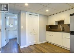 Kitchen towards bathroom in basement suite. - 