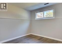 Second bedroom in basement suite towards back yard. - 