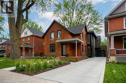 virtual ideas open front porch with rebuilt 2 story addition .Brick exterior with a contemporary black-framed window and door addition - 