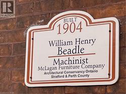 Architectural plaque mounted on a brick exterior - 