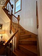 Hardwood staircase with turned balusters and a wood handrail - 