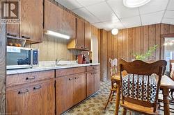 Kitchen featuring wood-finish cabinetry and a white countertop - 