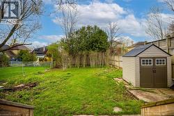 Expansive grassy yard area with perimeter fencing - 