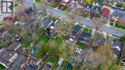 Aerial perspective showcasing a residential neighborhood with varied architectural styles and mature trees - 