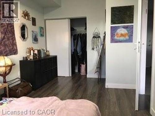 Wood-finish flooring provides a cohesive aesthetic throughout the space, complemented by light-colored walls - 280 Lester Street Unit# 607, Waterloo, ON 