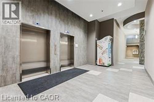 Twin stainless steel elevators set within a textured wall - 280 Lester Street Unit# 607, Waterloo, ON 