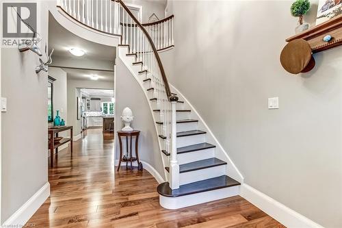 The entrance foyer features the staircase from the original home. - 59 Decou Road, Simcoe, ON 