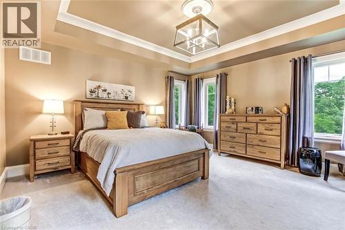 Spacious primary bedroom with tray ceiling, two walk in closets and large ensuite. - 59 Decou Road, Simcoe, ON 