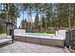 Enjoy year-round relaxation in the impressive swim spa, perfect for exercise, entertaining, or unwinding after a long day. - 