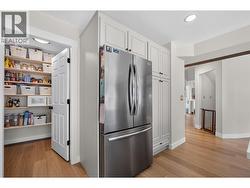 PantrWalk-in pantry offering exceptional storage and organization, keeping everyday essentials tucked away while maximizing kitchen functionality. - 