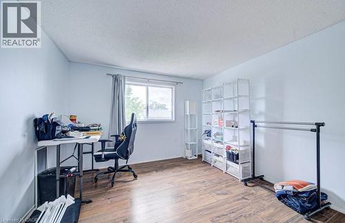 Room featuring wood-finish flooring, light blue walls, and a white ceiling - 854 Elgin Street N, Cambridge, ON 
