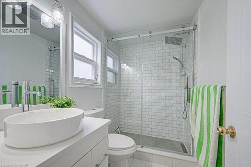 Modern bathroom featuring a glass-enclosed shower with subway tile surround, rainfall showerhead, and handheld sprayer - 854 Elgin Street N, Cambridge, ON 