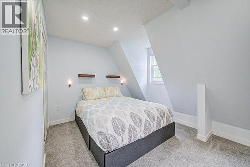 Carpeted bedroom featuring a sloped ceiling, recessed lighting, and a single window - 854 Elgin Street N, Cambridge, ON 
