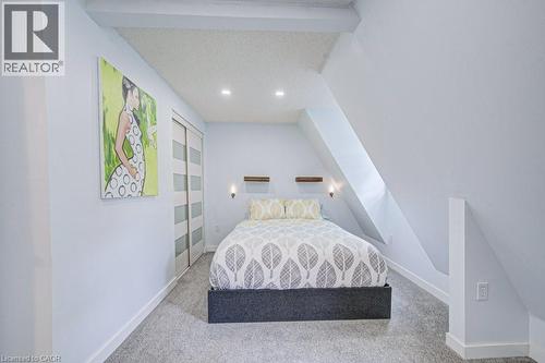 Bedroom featuring a neutral color palette, recessed ceiling lighting, and soft gray carpeting - 854 Elgin Street N, Cambridge, ON 