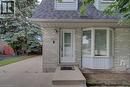 Front exterior featuring light-colored brick siding and a contrasting dark shingle roof - 854 Elgin Street N, Cambridge, ON 