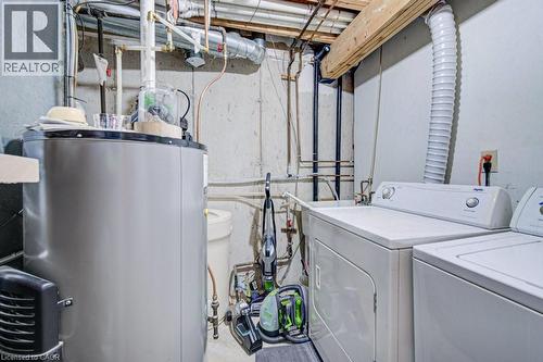 Dedicated utility area featuring a water heater, washer, and dryer - 854 Elgin Street N, Cambridge, ON 