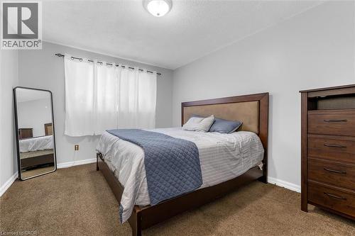 Carpeted bedroom with light gray wall paint and white trim - 338 East 24Th Street, Hamilton, ON 