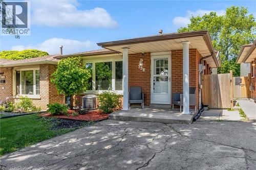 Brick exterior featuring a covered front porch with white columns - 338 East 24Th Street, Hamilton, ON 