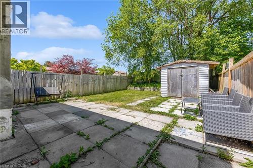 Expansive backyard featuring a combination of concrete patio and natural grass areas - 338 East 24Th Street, Hamilton, ON 