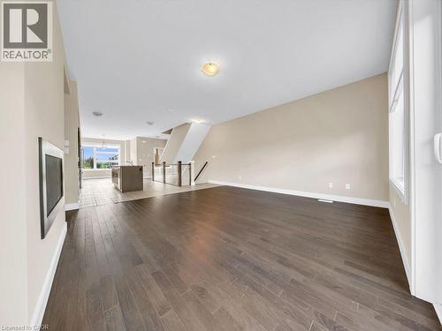 Spacious interior featuring wood-finish flooring, light neutral wall tones, and recessed ceiling lighting - 60 Arkell Road Unit# 51, Guelph, ON 
