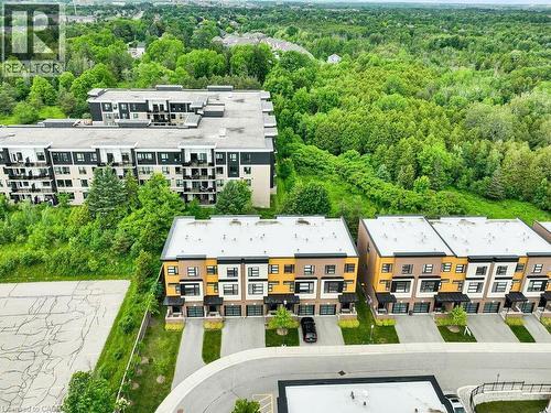 Row of modern townhomes with private driveways, integrated garages, and contemporary facades - 60 Arkell Road Unit# 51, Guelph, ON 
