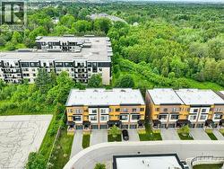 Row of modern townhomes with private driveways, integrated garages, and contemporary facades - 