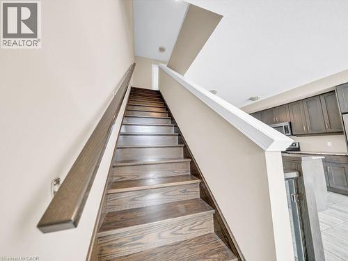 Hardwood staircase with a dark finish handrail and treads - 60 Arkell Road Unit# 51, Guelph, ON 