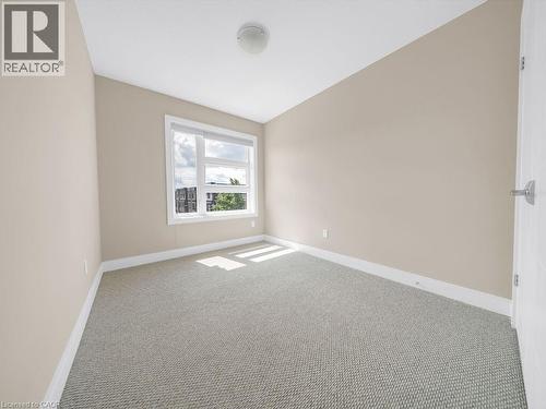 Neutral-toned walls and light-colored carpet flooring create a bright interior space - 60 Arkell Road Unit# 51, Guelph, ON 
