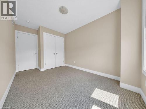 Neutral-toned carpeting grounds this room featuring a window with natural light - 60 Arkell Road Unit# 51, Guelph, ON 