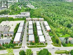 Modern townhome community featuring contemporary architecture with flat roofs and distinct facades - 