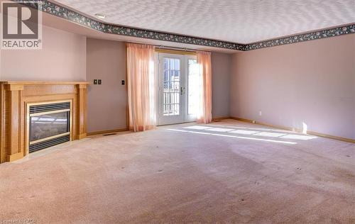 Enjoy a seamless indoor-outdoor flow with triple garden doors that fill the room with sunshine and greenery. - 42 Donly Drive S Unit# 2, Simcoe, ON 