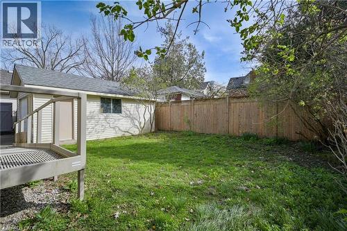 Spacious lawn area with a wood privacy fence - 25 Ahrens Street W, Kitchener, ON - Outdoor