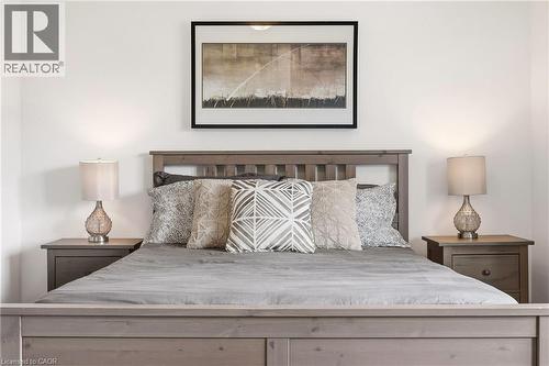 Bedroom featuring a wood-finish bed frame and matching nightstands - 4171 Palermo Common, Burlington, ON - Indoor Photo Showing Bedroom