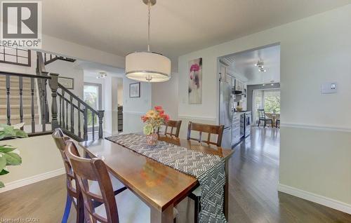 Dining area featuring wood-finish flooring and a contemporary drum pendant light fixture - 108 Clearwater Crescent, Waterloo, ON - Indoor Photo Showing Dining Room