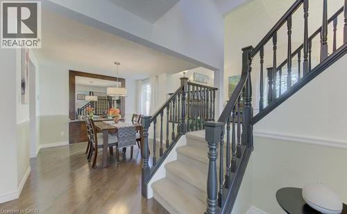Grand staircase with dark wood-finish balusters and carpeted treads - 108 Clearwater Crescent, Waterloo, ON - Indoor