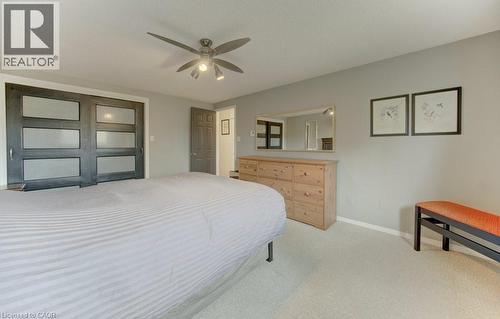 Spacious room featuring light-colored carpeting, a ceiling fan with integrated lighting, and a neutral wall color - 108 Clearwater Crescent, Waterloo, ON - Indoor Photo Showing Bedroom
