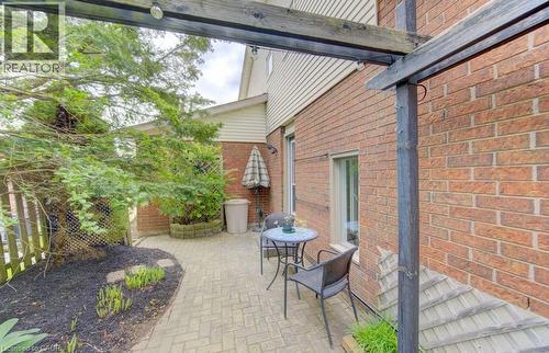 Brick exterior featuring a wood pergola with integrated lighting - 108 Clearwater Crescent, Waterloo, ON - Outdoor With Exterior