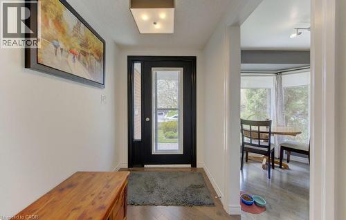 Entryway featuring a black door with a full-light window, wood-finish flooring, and a flush-mount ceiling light - 108 Clearwater Crescent, Waterloo, ON - Indoor Photo Showing Other Room
