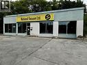 Commercial storefront building featuring a brick and horizontal siding facade - 3052 New Street, Burlington, ON 