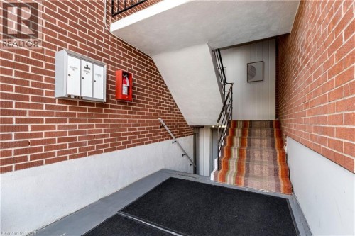 Brick wall exterior with white painted lower half - 43 Sixth Avenue, Kitchener, ON - Indoor Photo Showing Other Room