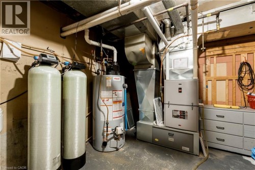 Mechanical room featuring a water heater, two water filtration tanks, and a forced-air furnace with associated ductwork - 43 Sixth Avenue, Kitchener, ON - Indoor Photo Showing Basement