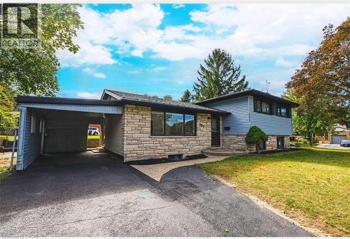 Tri-level home with stone siding, a front lawn, a carport, and driveway - 267 Erb Street E, Waterloo, ON - Outdoor