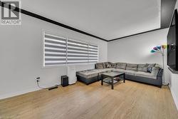 Living area with light wood-style floors and baseboards - 