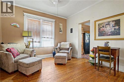 Living space featuring hardwood flooring, a ceiling fan, and a double window with blinds - 30 Hohner Avenue, Kitchener, ON - Indoor Photo Showing Living Room