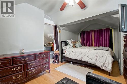 3rd Floor bedroom featuring wood-finish flooring, a ceiling fan with integrated lighting - 30 Hohner Avenue, Kitchener, ON - Indoor Photo Showing Bedroom