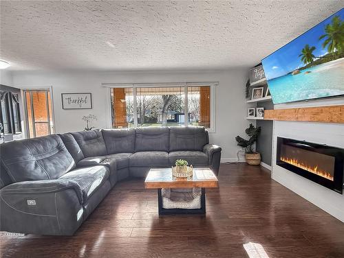 109 Noonan Drive, Brandon, MB - Indoor Photo Showing Living Room With Fireplace