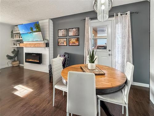 109 Noonan Drive, Brandon, MB - Indoor Photo Showing Dining Room With Fireplace