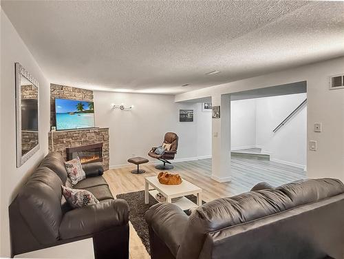 109 Noonan Drive, Brandon, MB - Indoor Photo Showing Living Room With Fireplace