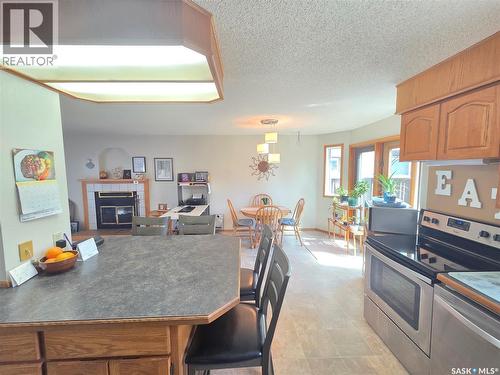 509 Carlyle Avenue, Carlyle, SK - Indoor Photo Showing Kitchen With Fireplace